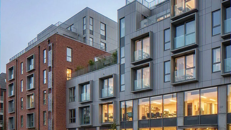 Exterior CGI of a mixed-use block with projecting window frames and ground-floor glazing