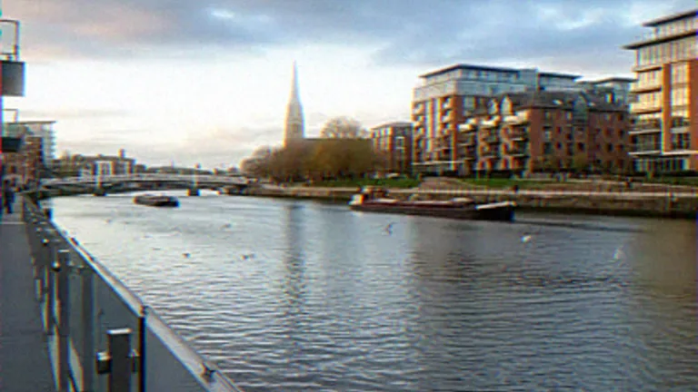 Exterior CGI of a river promenade with glass balustrades and moored canal boats