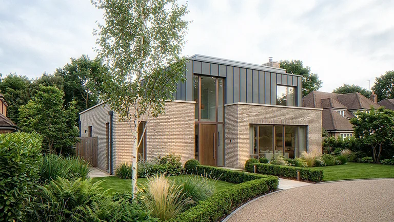Exterior CGI of the same detached house in daylight, brick base and zinc upper storey from the garden