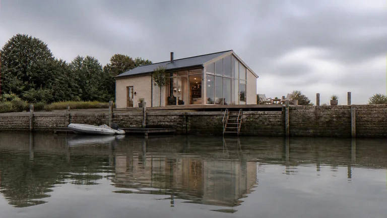 Waterfront CGI of a quayside house looking from the water toward the quay and flood deck